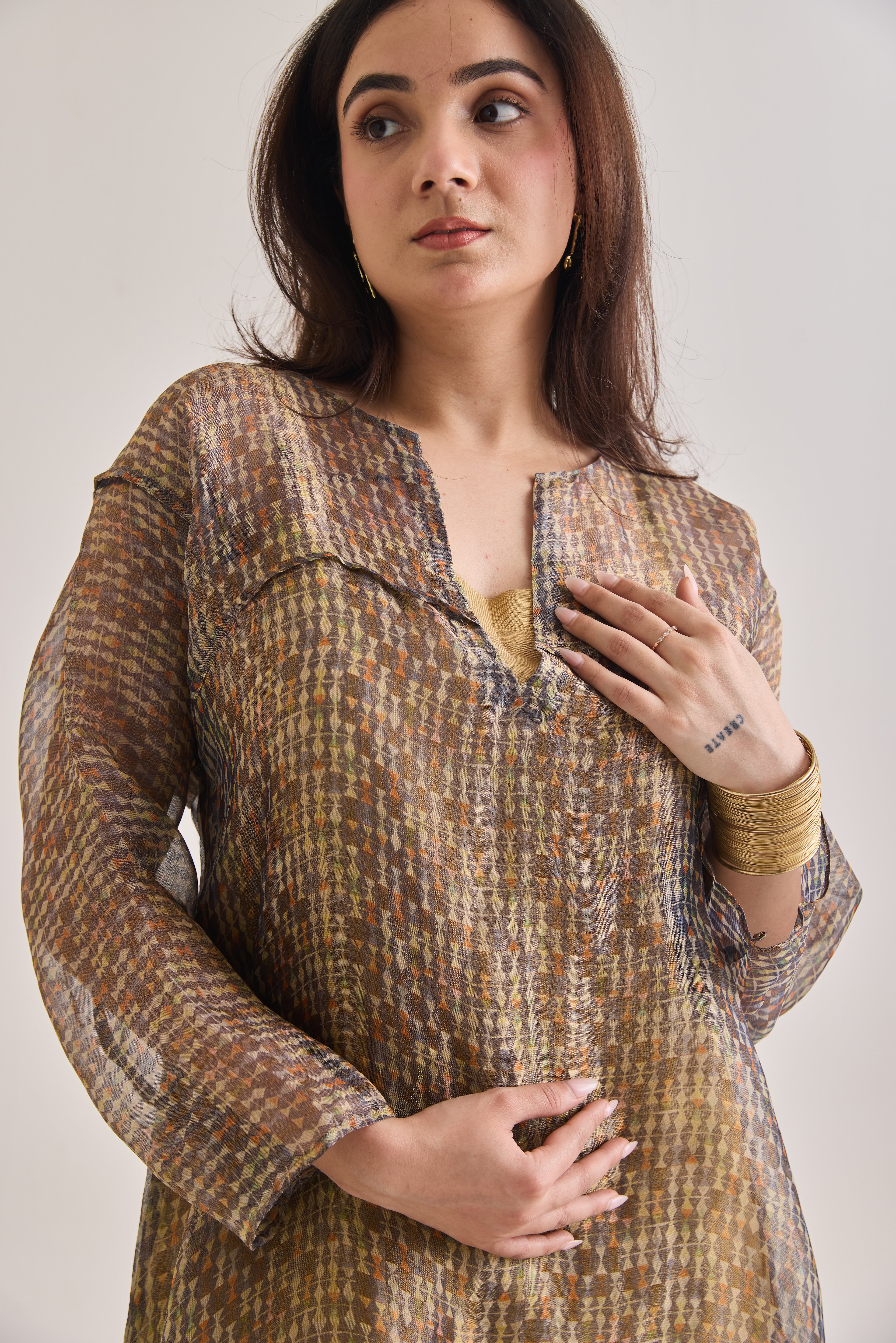 Close-up view of a layered co-ord set comprising of Banarasi Kurta With printed Tissue Organza Loose overlay Top