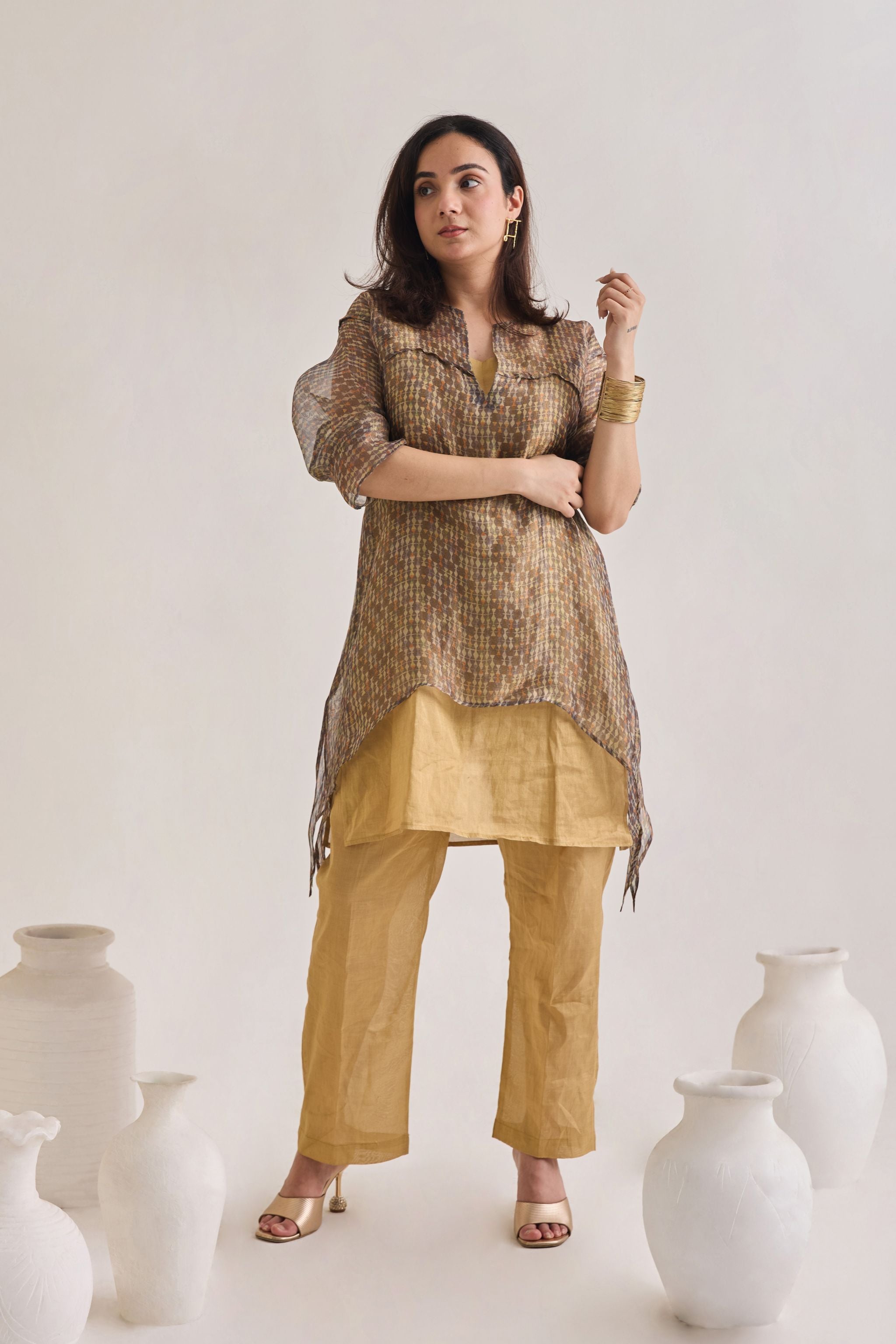 Front view of a layered co-ord set comprising of Banarasi Kurta With printed Tissue Organza Loose overlay Top and golden banarsi pants