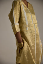 Close up view of Golden banarsi kurta with 3/4th sleeves and pin tuck detail and pants with pockets