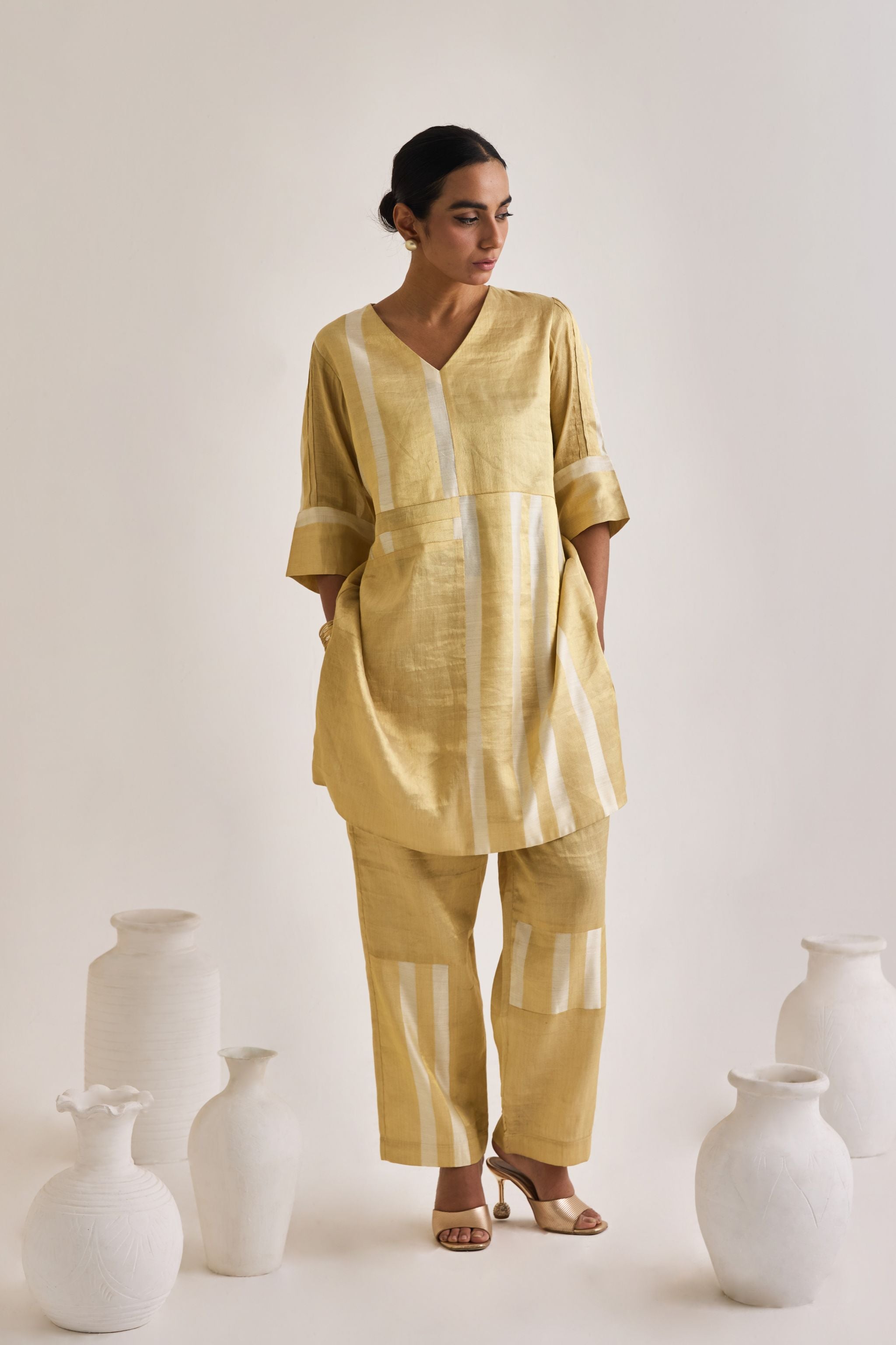 Front view of golden Banarsi co-ord set made using pure banarsi fabric with a blocked design on Kurta and pants