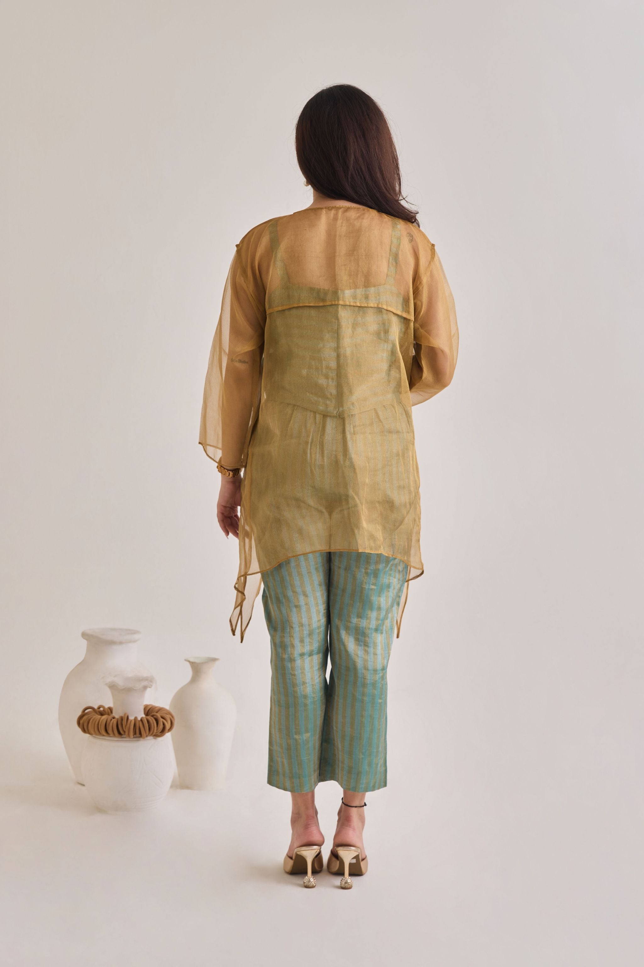 Back view of a banarsi teal and golden baggy and oversized 3 piece co-ord set with striped pants and slip