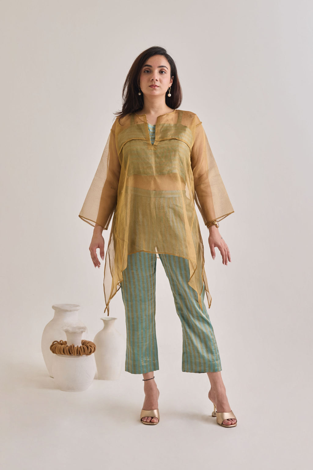 Front view of a banarsi teal and golden baggy and oversized 3 piece co-ord set with striped pants and slip