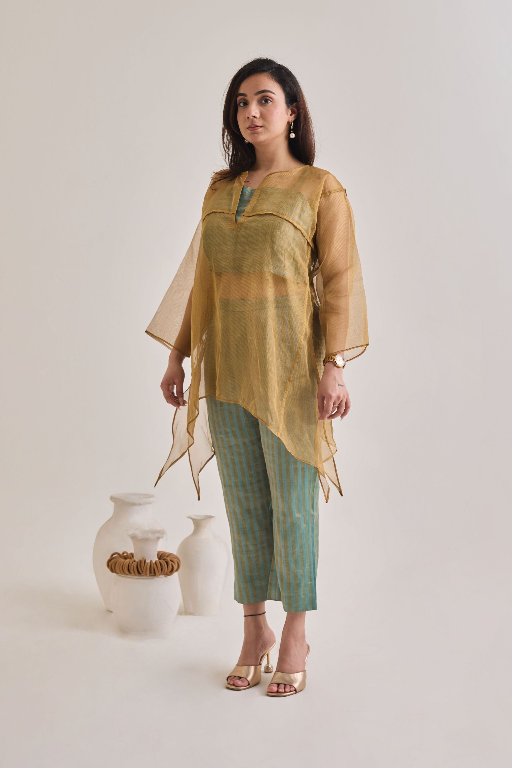 Side view of a banarsi teal and golden baggy and oversized 3 piece co-ord set with striped pants and slip