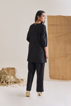 Back view of Black Chanderi short kurta with 3/4th sleeve and bell bottom pants with pintuck detail