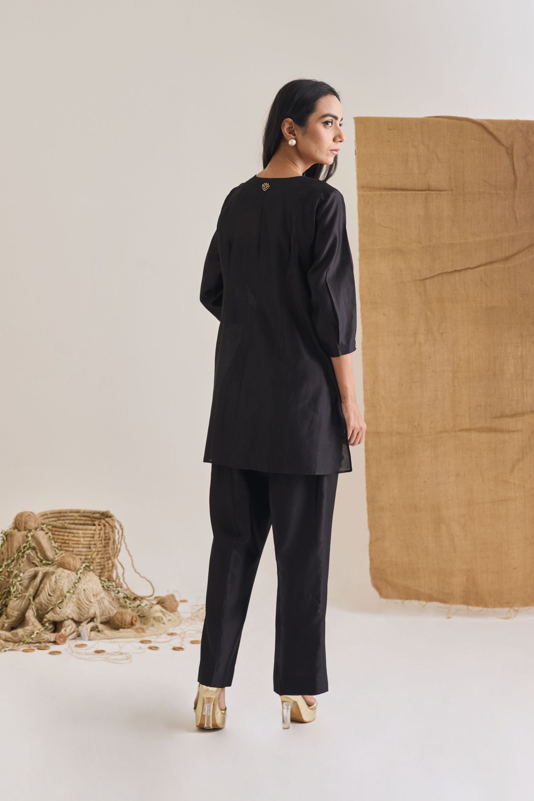 Back view of Black Chanderi short kurta with 3/4th sleeve and bell bottom pants with pintuck detail