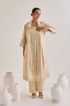 Front view of Chanderi set with a Long coat having notched collar, Fringed stripes Kurta and crease pants