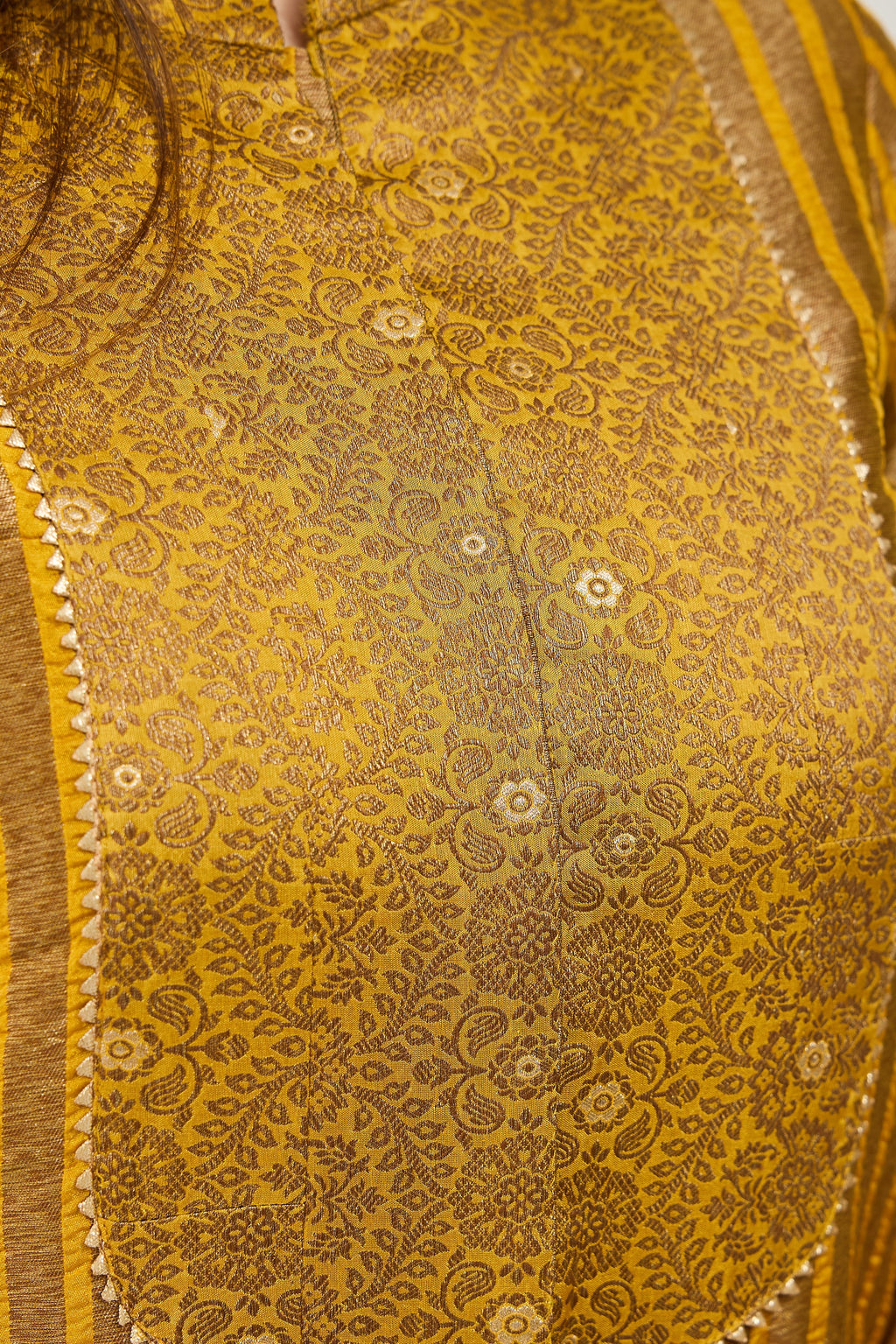 Close-up of Banarasi Kimkhab jacquard neck patch with golden lace on a mustard gold kurta