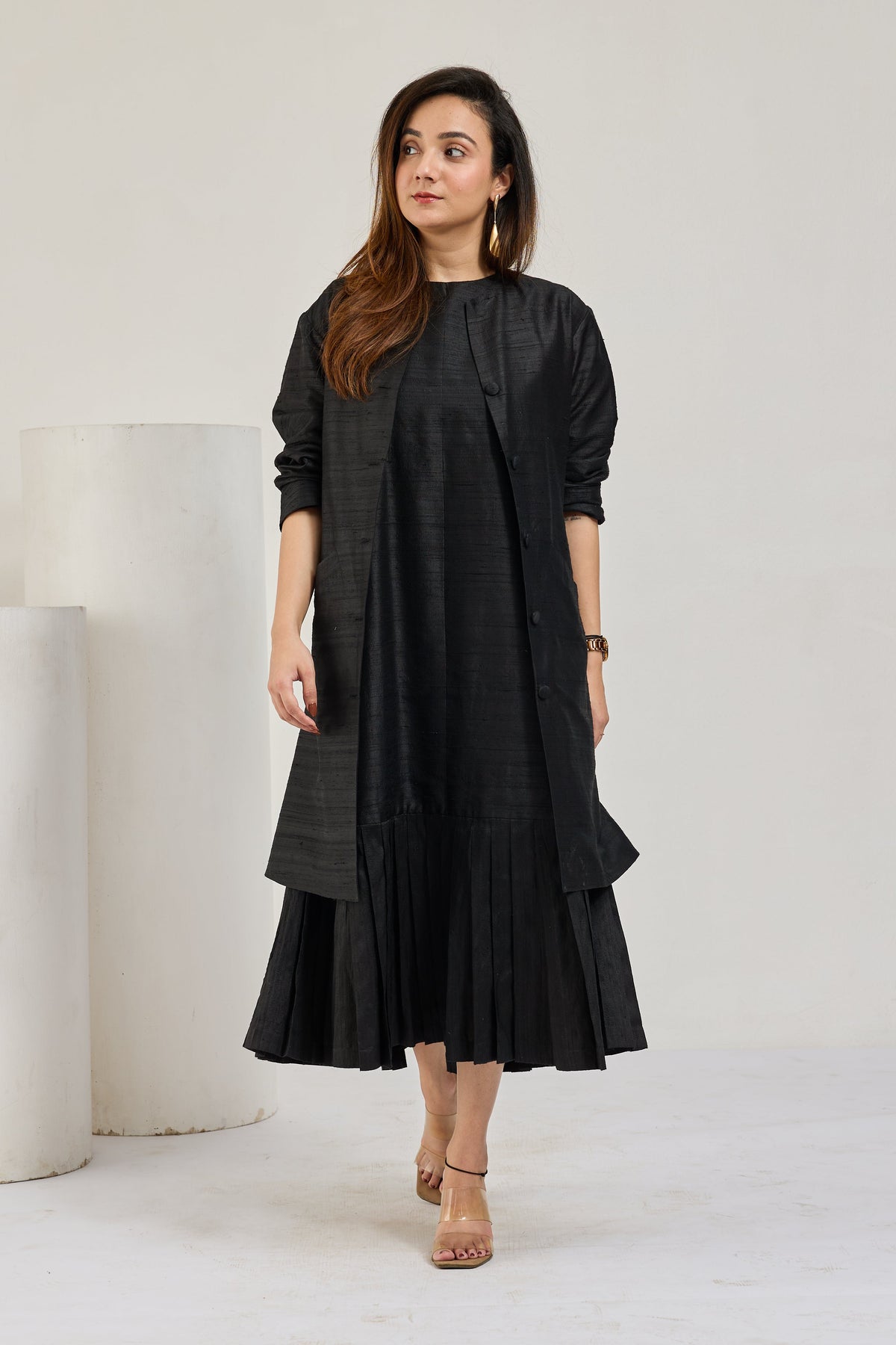 Black raw silk sleeveless midi dress with knee-length coat by Essence by Monika, front view