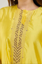 Close-up of golden dori embroidery on a bright yellow Katan silk kurta