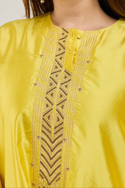 Close-up of golden dori embroidery on a bright yellow Katan silk kurta