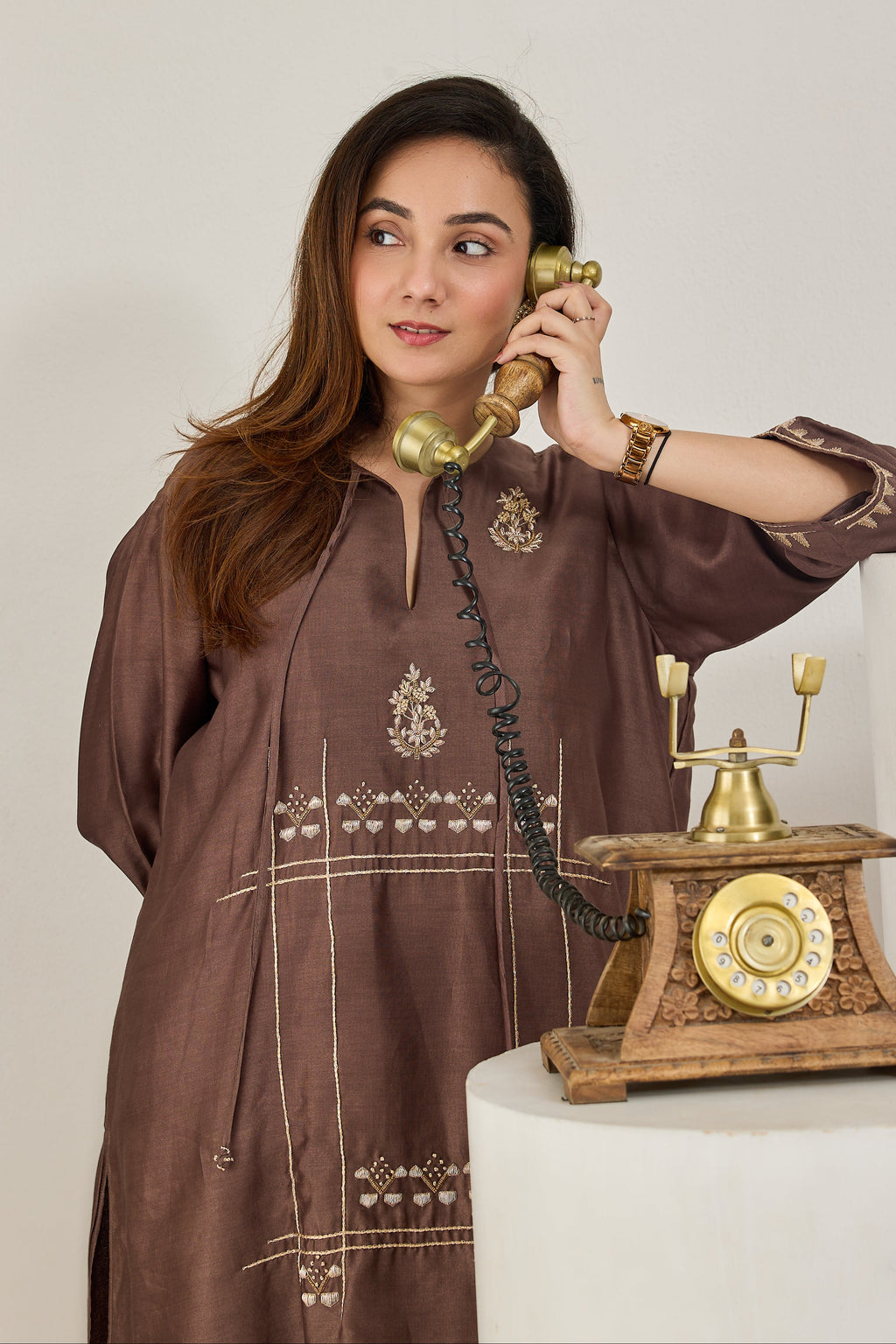 Close-up of hand dabka and zari embroidery on the front of a brown Chanderi kurta
