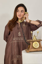 Close-up of hand dabka and zari embroidery on the front of a brown Chanderi kurta