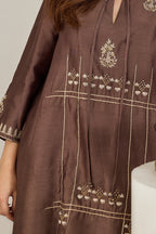 Close-up of the front dori tie with zari French-knot balls on a brown Chanderi kurta
