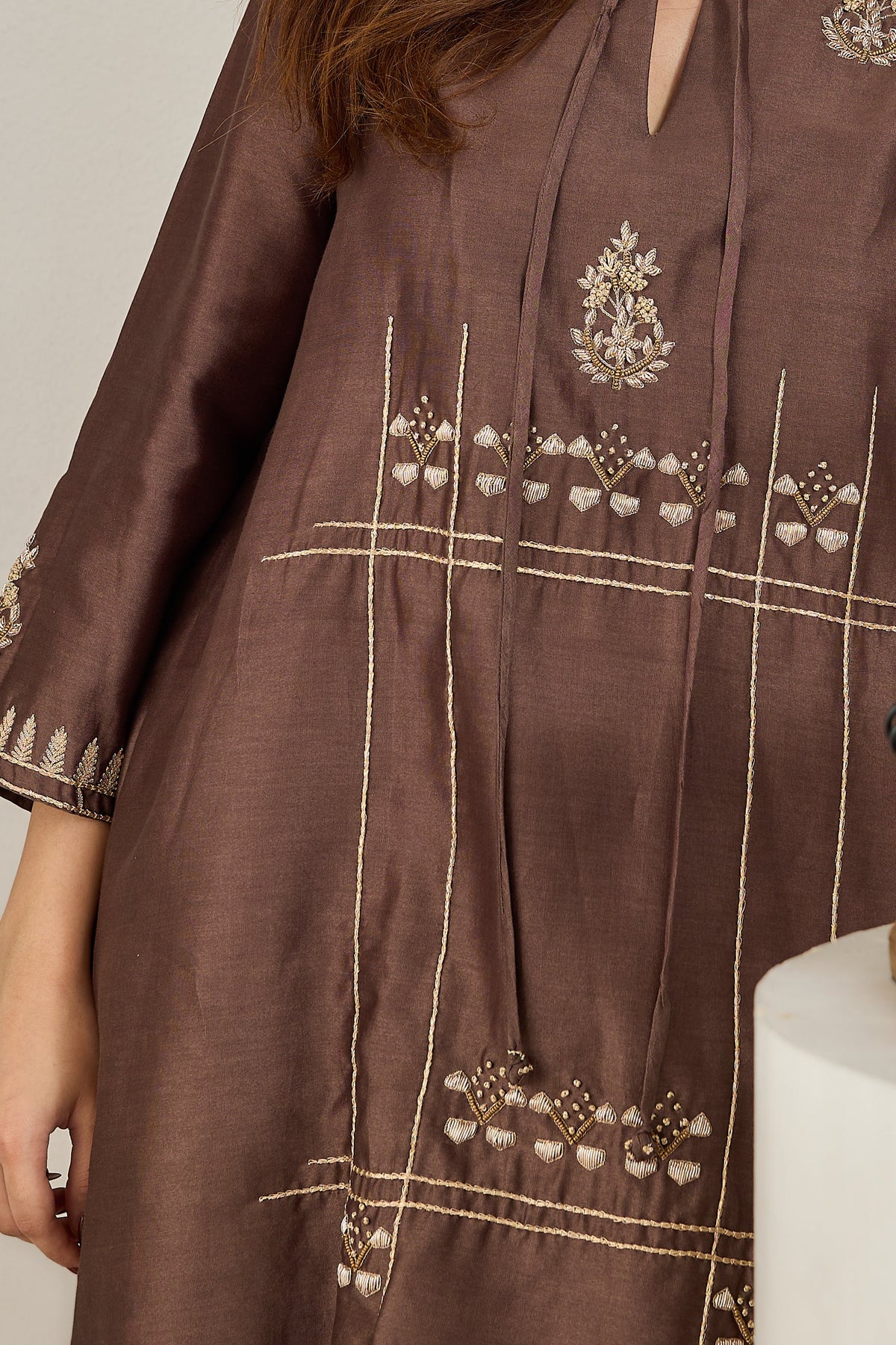 Close-up of the front dori tie with zari French-knot balls on a brown Chanderi kurta