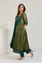 Dark green silk kurta set with long sheer metallic green Chanderi coat and 3/4 cuffed sleeves, side view