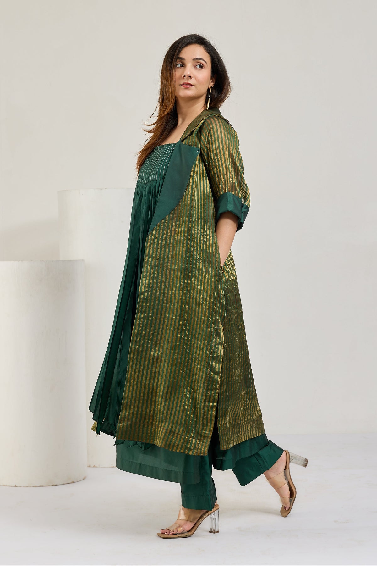 Dark green silk kurta set with long sheer metallic green Chanderi coat and 3/4 cuffed sleeves, side view