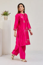 Model in fuchsia Chanderi kurta set with 3/4 sleeves and zari French-knot dori tie, looking to the left