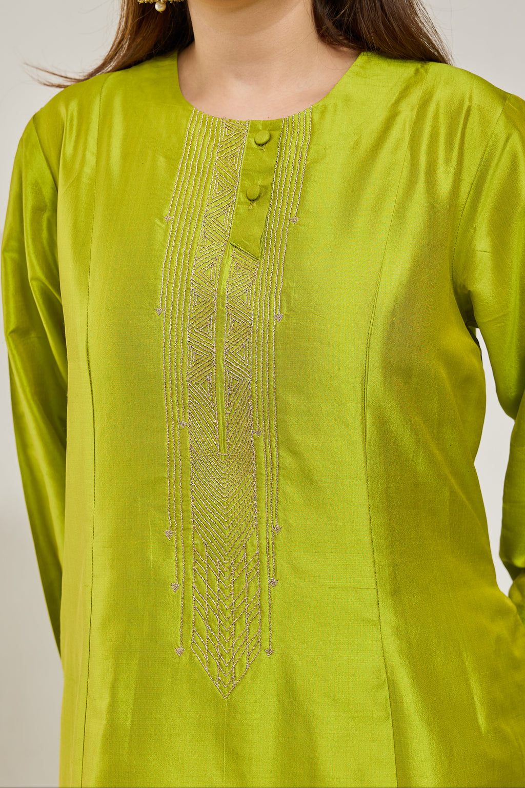 Close-up of golden dori embroidery on the neckline of a lime green Katan silk kurta