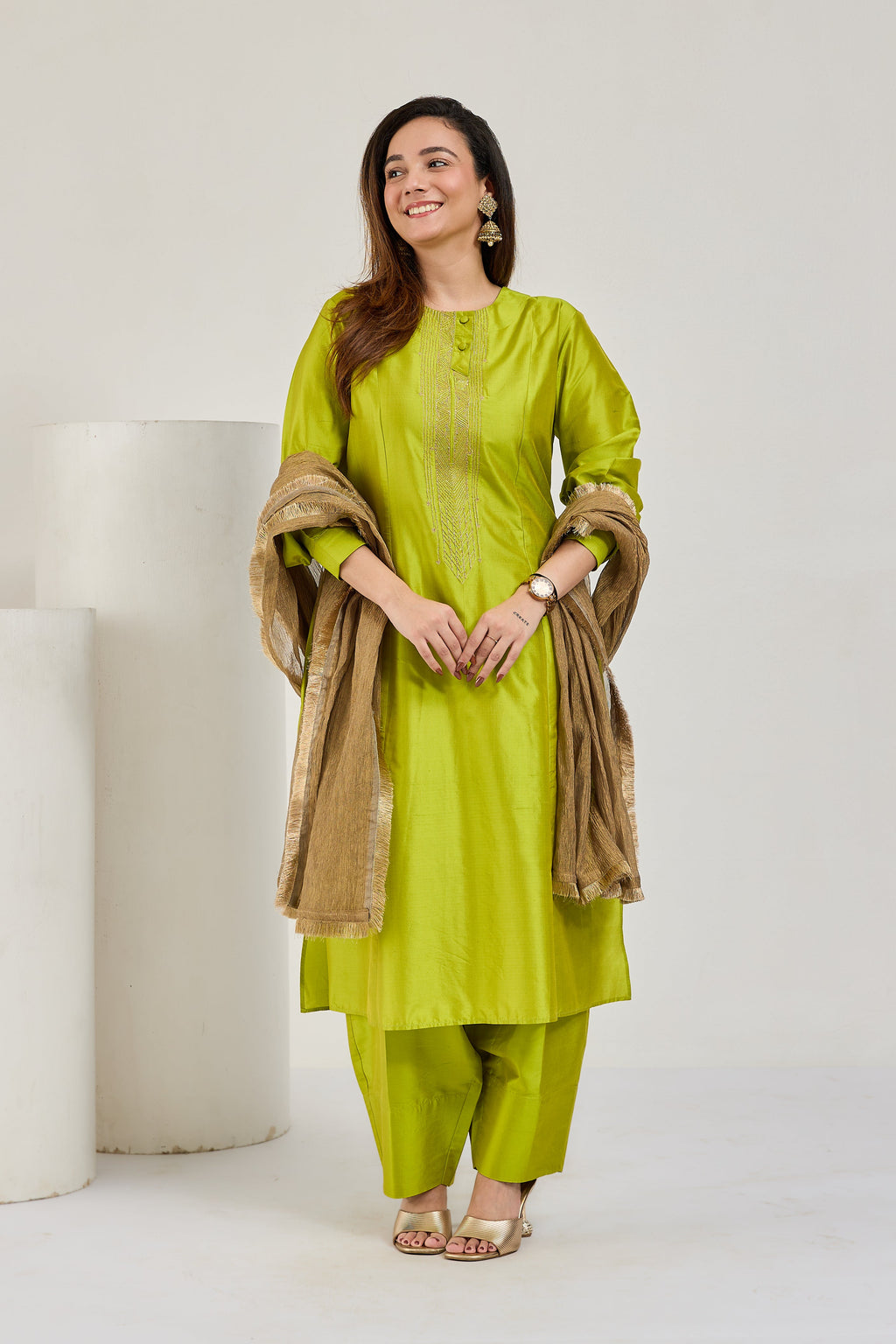 Model in lime green Katan silk kurta set with golden Kiran-edged tissue dupatta, looking to the left