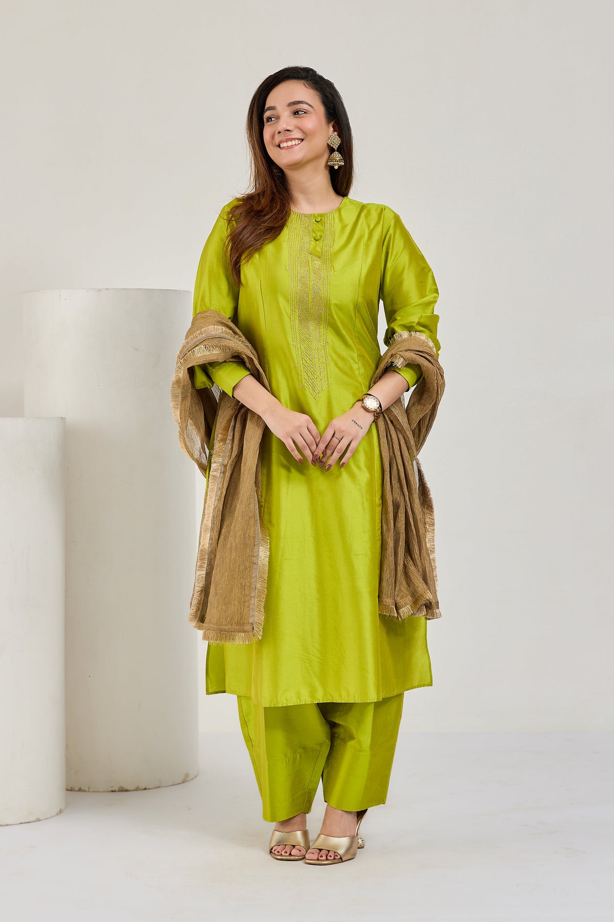 Model in lime green Katan silk kurta set with golden Kiran-edged tissue dupatta, looking to the left