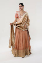 Peach Peach tissue + Banarasi silk + Banarasi Munga + Crushed Tissue Lehenga - front view | Essence by Monika