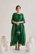 Green suit with 3/4th sleeves and a tie up neck with salwar made out of crushed silk fabric with Golden gota detail and accessorized with a Drawstring Bag