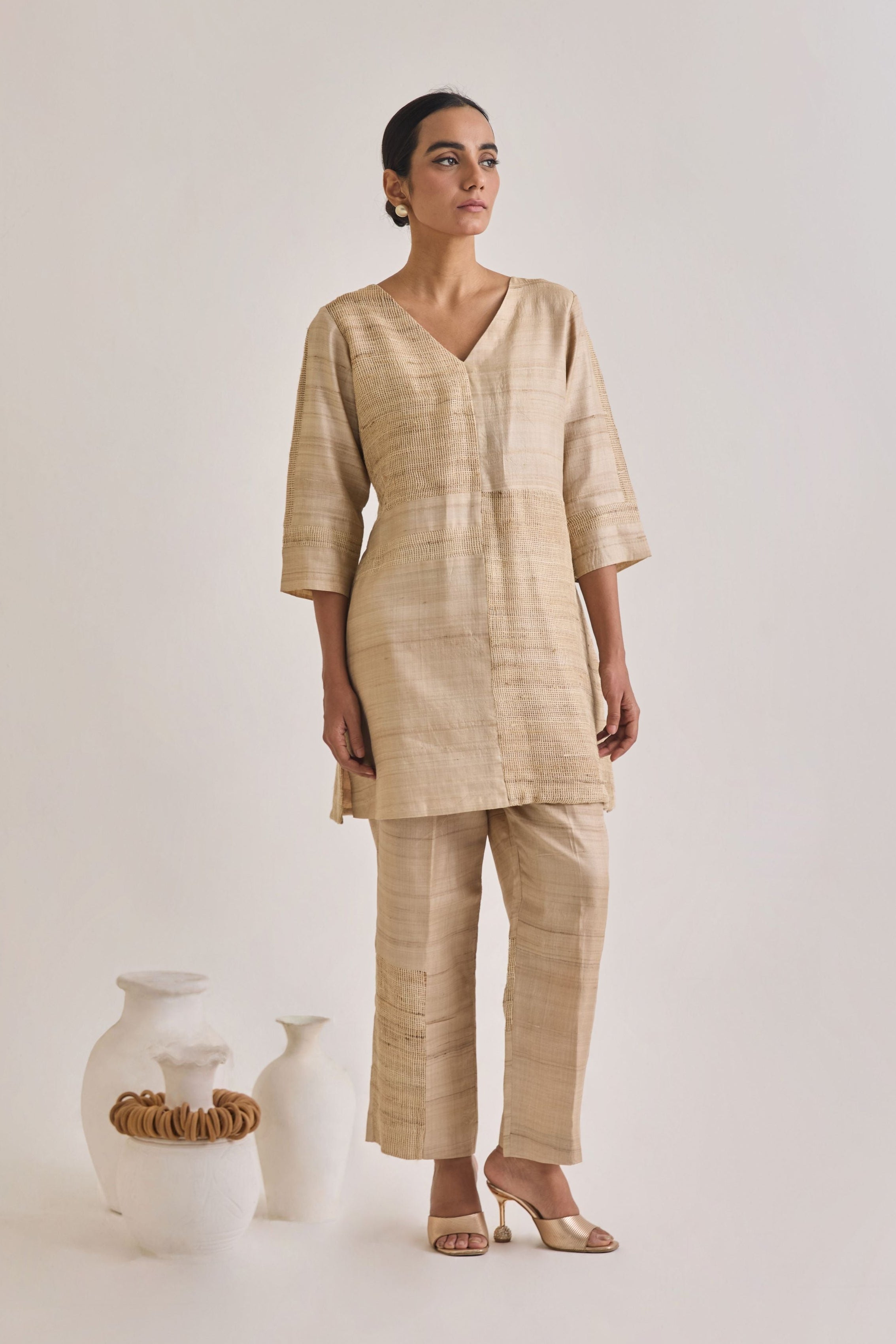 Front view of co-ord set with a V-neckline and straight pants having a blocked panel design made out of Hathkarga fabric and kora raw tussar