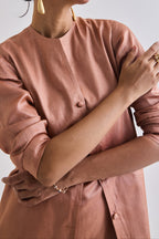 Detailed close up of Tussar coat with slant pockets and full sleeve rolled up to elbow