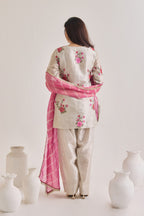Back view of Silver and pink Farsi suit salwar set made out of Silver tissue with a machine embroidered rose motif kameez having 3/4th sleeves, a farsi salwar and Pink organza laheriya print dupatta paired with a Potli Bag.