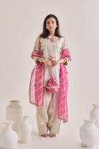 Front shot of Silver and pink Farsi suit salwar set made out of Silver tissue with a machine embroidered rose motif kameez having 3/4th sleeves and tie neck detail, a farsi salwar and Pink organza laheriya print dupatta paired with a Potli Bag.
