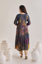 Back profile of multicolour suit made out out of crushed silk fabric with 3/4th length sleeves having gota border at sleeve opening and Dori neckline, paired with a pair of mustard Golden Gota border salwar.
