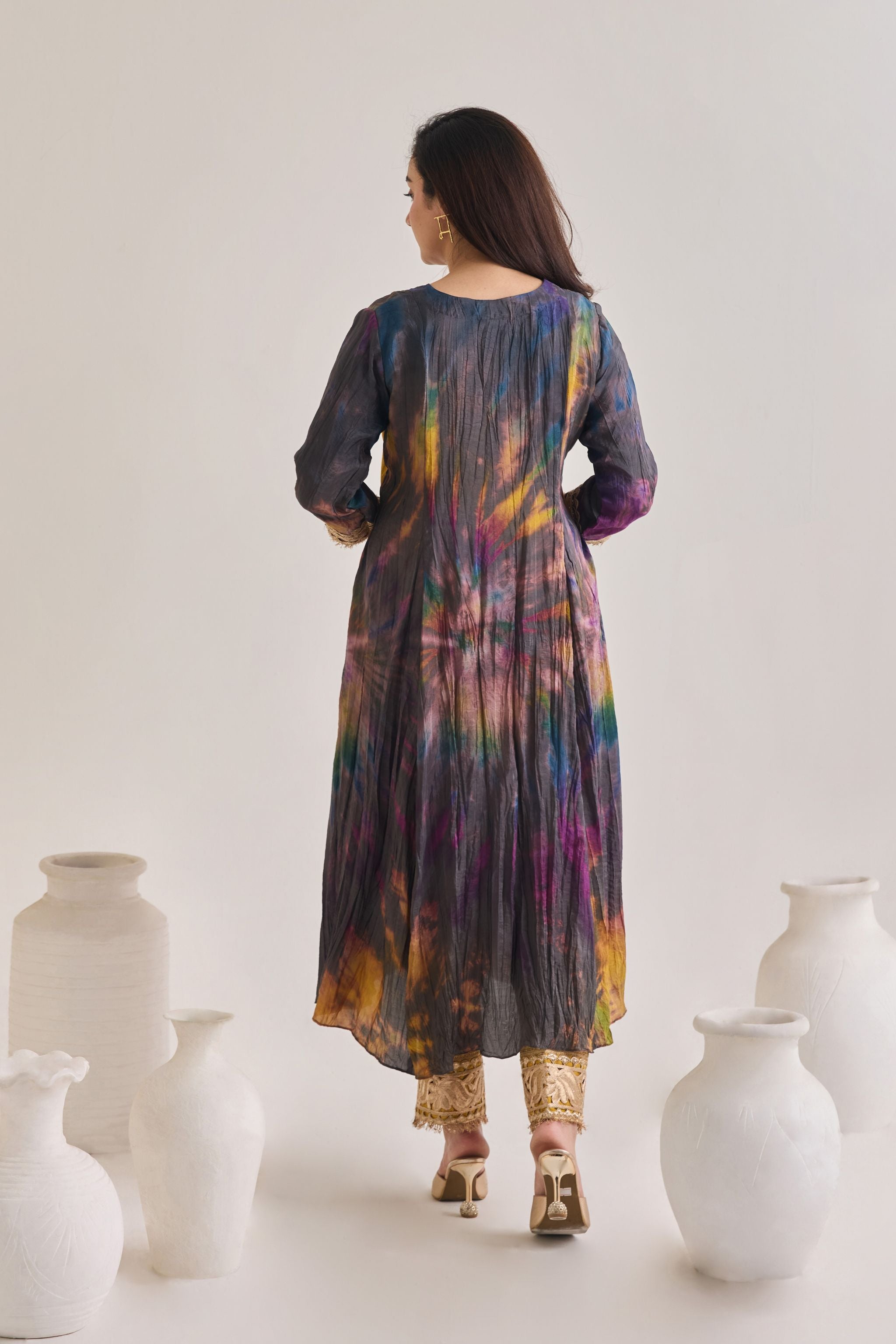 Back profile of multicolour suit made out out of crushed silk fabric with 3/4th length sleeves having gota border at sleeve opening and Dori neckline, paired with a pair of mustard Golden Gota border salwar.